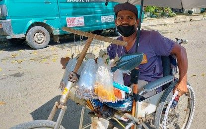 <p><strong>IMPROVISED WHEELCHAIR.</strong> Despite his disability, life goes on for Ramel Bangkas, 49, who traverses a road in Quimpo Boulevard, Davao City on Nov. 10, 2023 using an improvised wheelchair. He vowed that he would continue providing for his family by selling spices using his wheelchair.<em> (PNA photo by Robinson Niñal Jr.)</em></p>