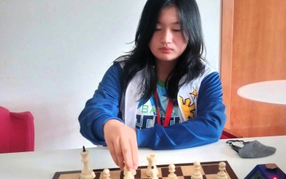 <p><strong>2ND</strong> <strong>VICTORY</strong>. Filipino Jirah Floravie Cutiyog makes her move against Zuzanna Gaszka of Poland during the second round of the FIDE World Youth Chess Championships at the Pala Dean Martin Centro Congressi in Montesilvano City, Italy on Tuesday. Cutiyog won in 42 moves of the Caro-Kann Defense, Advance variation to gain a share of the lead in the girls U14 category. (<em>Contributed</em> <em>photo</em>)</p>