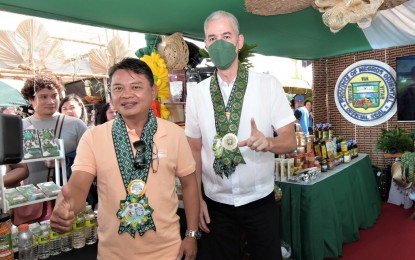 <p><strong>ORGANIC FARMING EXHIBIT.</strong> Negros Occidental Governor Eugenio Jose Lacson (right) joins Negros Oriental OIC Provincial Agriculture Officer Emmanuel Caduyac during the opening of the 16th Negros Island Organic Farmers Festival at the Provincial Capitol grounds in Bacolod City Wednesday (Nov. 15, 2023). Themed “Regeneration for Future Generations,” the five-day festival highlights the importance of eco-friendly farming practices, emphasizing sustainable regenerative farming. (<em>Photo courtesy of PIO Negros Occidental</em>)</p>