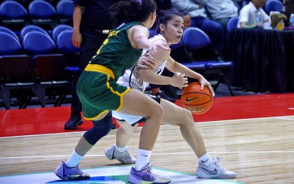 <p><strong>TWICE-TO-BEAT BID.</strong> University of Santo Tomas player Brigette Santos (right) protects the ball during the game against Far Eastern University in the UAAP Season 86 women's basketball tournament at the SMART Araneta Coliseum on Wednesday (Nov. 15, 2023). UST won, 106-85, to keep the twice-to-beat incentive bid in the Final Four.<em> (Photo courtesy of UAAP)</em></p>
