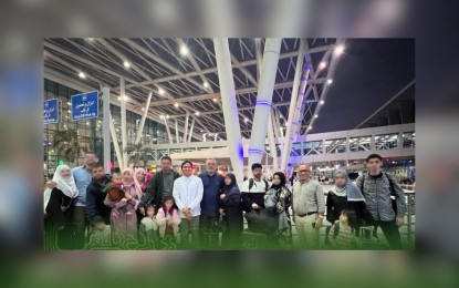 <p><strong>REPATRIATES FROM GAZA.</strong> The 13 Filipino repatriates and their families pose for a photo while waiting for their flight back to the Philippines from Egypt on Nov. 14, 2023. The Department of Social Welfare and Development on Friday (Nov. 17) said it has already extended PHP5.4 million worth of aid to 272 overseas Filipino workers and other overseas Filipinos since the repatriation started on Oct. 18. <em>(Photo courtesy of the Philippine Embassy in Egypt)</em></p>