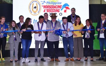 <p><strong>RIBBON-CUTTING CEREMONY.</strong> A photo taken on Nov. 14, 2023 shows Philippine Charity Sweepstakes Office general manager Mel Robles (4th from right) and Philippine Racing Commission chairman Reli de Leon (5th from left) during the opening of the second Philippine Horseracing and Breeding Expo at the Sta. Lucia East Grand Mall in Cainta. The three-day event aimed to bring the industry closer to the general public. <em>(Philracom photo)</em></p>
