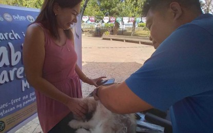 <p><strong>ANTI-RABIES CAMPAIGN</strong>. A pet owner avails of free vaccination for her dog in this undated photo. Iloilo province has procured anti-rabies vaccines to cover 70 percent of the dog population in the province.<em> (Photo from Provincial Veterinarian’s Office FB page)</em></p>