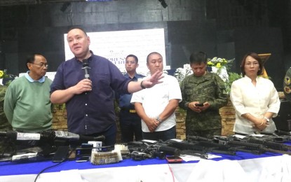 <p><strong>RECONSTRUCTION BID</strong>. Defense Secretary Gilberto Teodoro (second from left) answers queries from the media on the sidelines of the turnover of assistance to former rebels who voluntarily surrendered in the province of Apayao. Teodoro said he is taking advantage of his presence in the province to meet and discuss with officials of Apayao and Cagayan about the National Disaster Risk Reduction and Management Council’s reconstruction of vital arteries damaged by super typhoon Egay in July 2023. <em>(PNA photo by Liza T. Agoot)</em></p>