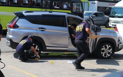 <p><strong>GUNNED DOWN.</strong> Scene of the crime operatives check on the vehicle of former mayor Giselo Velasco Castillones of Cateel, Davao Oriental after he was shot dead by a still unidentified gunman in Davao City on Wednesday morning (Nov. 22, 2023). The victim was with two other companions and was about to leave a fast food chain outlet when approached and fired upon by the attacker. <em>(PNA photo by Robinson Niñal Jr.)</em></p>