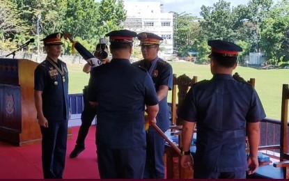 <p><strong>TURN-OVER OF COMMAND</strong>. Philippine National Chief Gen. Benjamin Acorda Jr. (third from left) hands over the flag to Brig. Gen. Lou Evangelista, the new acting regional director of the Ilocos Police Regional Office on Wednesday (Nov. 22, 2023) at the PRO-1 in San Fernando City, La Union. Evangelista replaced Brig. Gen. John Chua (left). <em>(Photo screenshot from PRO-1 livestream)</em></p>