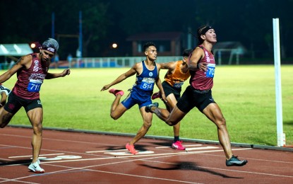 <p><strong>FASTEST ATHLETE.</strong> University of the Philippines bet Alhryan Labita crosses first the finish line in the men's 100-meter final to win the gold in the UAAP Season 86 athletics tournament at the PhilSports track and field stadium in Pasig City on Wednesday night (Nov. 22, 2023). Labita clocked 10.57 seconds to set a new record.<em> (UAAP photo)</em></p>
