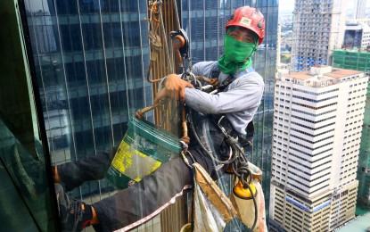 <p><strong>SOMEBODY'S GOT TO DO IT.</strong> A window cleaner of a high-rise building in Ortigas Avenue, Pasig City manages to smile amid another tough day at work on Nov. 21, 2023. The German Embassy in Manila is expecting increased interest among Filipinos to work in Germany with the new labor law that makes it easier for foreigners with vocational training to migrate.<em> (PNA photo by Joan Bondoc)</em></p>