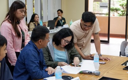 <p><strong>PROGRESS ASSESSMENT</strong>. The Regional Agricultural Engineering Division of the Department of Agriculture in Calabarzon conducted a year-end assessment on the status of farm-to-market road development projects on Nov. 15, 2023. DA and Department of Public Works and Highways officials are photographed discussing the accomplishments of each District Engineering Office. <em>(Photo courtesy of DA-4A)</em></p>