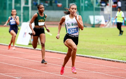 <p><strong>CHAMPION.</strong> National athlete Bernalyn Bejoy leads the race during the 400m final of the University Athletic Association of the Philippines (UAAP) Season 86 athletics competition at the Philsports track oval in Pasig City on Saturday (Nov. 25, 2023). Bejoy took the gold medal in a photo finish over teammate Jessel Lumapas. <em>(Photo from UAAP)</em></p>