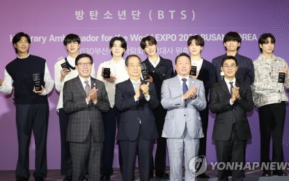 <p><strong>PROMOTIONAL ENVOYS. </strong>What better way to sway voters of the 2030 World Expo hosting than by tapping the seven members of the globally famous BTS band as ambassadors. Prime Minister Han Duck-soo (2nd from left, front row) joints BTS (back row) during the appointment ceremony in Seoul on July 19, 2022. <em>(Yonhap)</em></p>