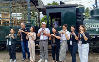 <p><strong>TOUR IN SILAY CITY.</strong> Tourism Secretary Christina Garcia Frasco (3rd from left) and other tourism officials show the "Love the Philippines" heart sign during their visit to the Hawaiian-Philippine Company sugar mill in Silay City, Negros Occidental on Wednesday (Nov. 29, 2023). Frasco led the launch of the Philippine Experience: Culture, Heritage and Arts Program Western Visayas leg of the Department of Tourism. (<em>PNA photo by Nanette L. Guadalquiver</em>)</p>