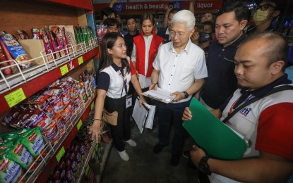 <p><strong>INTENSIFIED MONITORING.</strong> DTI Secretary Alfredo Pascual (wearing plain white) leads a market monitoring at a supermarket in Divisoria, Manila in this photo dated Nov. 29, 2023. Pascual reaffirmed the Department of Trade and Investment's commitment to protect consumers against hoarders and price manipulators ahead of La Niña phenomenon. <em>(PNA file photo by Yancy Lim)</em></p>