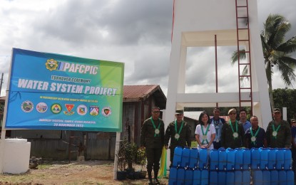 <p><strong>WATER SUPPLY PROJECT.</strong> Isabela, Negros Occidental Mayor Irene Montilla (3rd from left), along with officials of the Philippine Army and the Philippine Army Finance Center Producers Integrated Cooperative, leads the turnover of the elevated water storage tank to officials and residents of the Barangay Sikatuna on Wednesday (Nov. 29, 2023). The water facility will provide some 583 households in the remote border village with a steady water supply. <em>(Photo courtesy of 62nd Infantry Battalion, Philippine Army)</em></p>