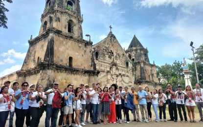 <p><strong>TOURISM CARAVAN.</strong> Tourism Secretary Christina Garcia Frasco poses with participants of the Philippine Experience: Culture, Heritage, and Arts Caravan at the St. Thomas de Villanova Church in Miagao, Iloilo on Thursday (Nov. 30, 2023). Frasco expressed optimism on the recovery of tourism and the resurgence of the economy by highlighting the unique cultural identities of the country’s regions as key tourist attractions. <em>(PNA photo by Perla G. Lena)</em></p>