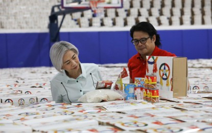 <p><strong>CHRISTMAS IS IN THE AIR. </strong>Manila Mayor Honey Lacuna (left) and Vice Mayor Yul Servo Nieto (right) inspect the Christmas gift boxes to be given to the city's households at the San Andres Sports Complex on Thursday (Nov. 30, 2023). The city government will heighten police visibility and add parking spaces to accommodate shoppers for the Christmas season. <em>(PNA photo by Yancy Lim)</em></p>