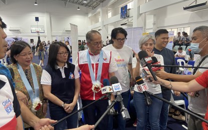 <p><strong>FOSTERING EMPLOYMENT.</strong> Labor Secretary Bienvenido Laguesma (center, wearing vest) and Manila Mayor Honey Lacuna (2nd from right) speak to reporters at the walkthrough of a job fair at Manila Science High School on Friday (Dec. 1, 2023). The Department of Labor and Employment distributed PHP8.5 million worth of cash and livelihood assistance to beneficiaries in Metro Manila, in celebration of its 90th founding anniversary. <em>(PNA photo by Ferdinand Patinio)</em></p>