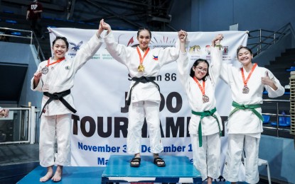<p><strong>PROUD WARRIOR</strong>. University of the East's Joemari-Heart Rafael (2nd from left) won the gold medal in the women's -52kg category of the UAAP Season judo tournament at the Marikina Sports Complex on Nov. 30, 2023. She is the Season 85 MVP and Rookie of Year.<em> (Photo courtesy of UAAP)</em></p>