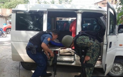 <p><strong>FOILED GUN SMUGGLING.</strong> Police agents inspect a white minivan in search of more firearms after a brief firefight in Barangay Kurintem, Datu Odin Sinsuat, Maguindanao del Norte, on Sunday (Dec. 3, 2023). The gunmen escaped. <em>(Photo courtesy of Datu Odin Sinsuat MPS)</em></p>