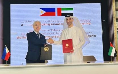 <p><strong>FORMAL TALKS</strong>. Trade Secretary Alfredo Pascual and United Arab Emirates Minister of State for Foreign Trade Dr. Thani bin Ahmed Al Zeyoudi hold the signed terms of reference of the Comprehensive Economic Partnership Agreement between Manila and Abu Dhabi following its signing on Dec. 2, 2023 in Dubai. This marks the commencement of the formal negotiations for the free trade agreement between the two countries. <em>(Photo courtesy of DTI)</em></p>