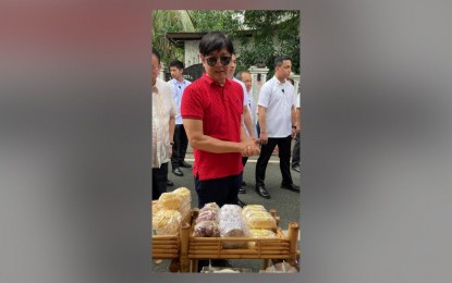 <p><strong>BREAD FOR PATRIOTS</strong>. President Ferdinand R. Marcos Jr. talks with bakers from Cuenca, Batangas, who showcased their bread products fortified with readily available crops during a trade show at the Malacañang grounds in Manila on Saturday (Dec. 2, 2023). The local bakery industry seeks more government support for their food self-sufficiency initiative. <em>(Photo courtesy of Tinapayan Festival)</em></p>