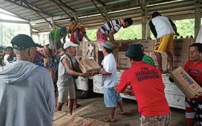 <p><strong>SUSTAINED RESPONSE</strong>. Department of Social Welfare and Development (DSWD) family food packs for five towns in quake-hit Surigao del Sur are unloaded on Wednesday (Dec. 6, 2023). The DSWD 13’s (Caraga) relief efforts have so far reached 21,615 distressed residents in the province. <em>(Photo courtesy of DSWD-13)</em></p>