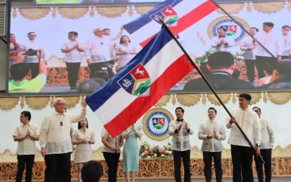 <p><strong>OLDER AND PROUD.</strong> Gov. Hermilando Mandanas (holding banner) and Vice Gov. Mark Leviste (4th from right) lead the 422nd Foundation Day ceremonies at the provincial capitol on Friday (Dec. 8, 2023). Provincial leaders also announced their environmental preservation goals. <em>(Photo courtesy of Batangas-PIO)</em></p>
