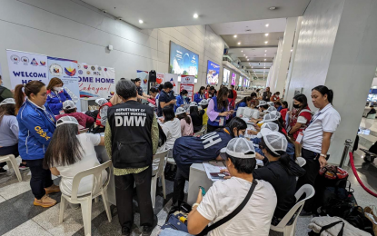 <p><strong>HOME FOR CHRISTMAS.</strong> The 11th batch of overseas Filipino workers (OFWs) from Israel arrive at the Ninoy Aquino International Airport Terminal 3 on Monday (Dec. 11, 2023). The Department of Migrant Workers said the group is composed of 25 caregivers and two hotel workers. <em>(Photo courtesy of DMW)</em></p>