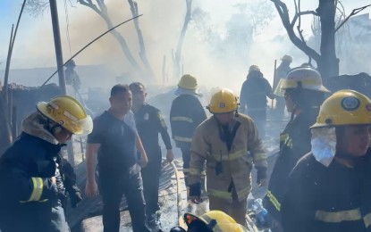 <p><strong>FIRECRACKER FACTORY.</strong> Mayor Junard Chan (left, in a fireman's suit) joins firefighters in checking the firecracker factory in Barangay Babag, Lapu-Lapu City that was razed by the fire Monday afternoon. Four persons, including the factory owner, died while several others were hurt during the blaze. <em>(Contributed photo)</em></p>