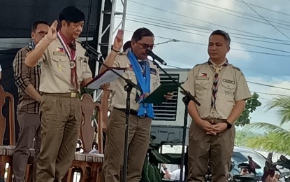 <p><strong>CHIEF BOY SCOUT.</strong> President Ferdinand R. Marcos Jr. (left) recites the Scout Oath and Law after his installation as Chief Scout of the Boy Scouts of the Philippines during the opening ceremonies of the 18th National Scout Jamboree in Passi City, Iloilo on Monday (Dec. 11, 2023). The jamboree gathered 35,000 scouts and scoutmasters for the event that will run until Dec 17. <em>(PNA photo by PGLena)</em></p>
