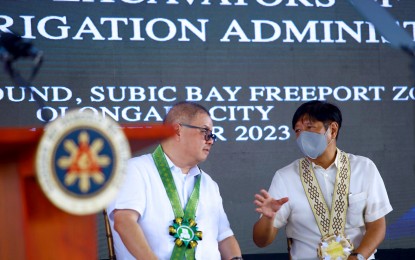 <p><strong>CONVERSATION WITH THE PRESIDENT.</strong> President Ferdinand R. Marcos Jr. (right) speaks to Agriculture Secretary Francisco Tiu Laurel Jr. during the turnover ceremonies of wheeled excavators to the National Irrigation Administration in a ceremony at Subic Bay Freeport in Zambales on Dec. 13, 2023. Senators Imee Marcos and Cynthia Villar on Tuesday (May 14, 2024) suggested that either the Office of the President or the Department of Agriculture should assume the power to intervene in the local rice market. <em>(PNA photo by Joan Bondoc)</em></p>