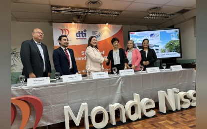 <p><strong>PARTNERSHIP</strong>. Monde Nissin People and Culture director Luz Mercurio and Philippine Trade Training Center (PTTC) Executive Director Nelly Dillera (3rd and 4th from left, respectively) sign a memorandum of agreement at the PTTC Office in Pasay City on Wednesday (Dec. 13, 2023). Through the partnership, retirees from Monde Nissin will be trained and equipped with entrepreneurial skills they can use after their tenure at the company. <em>(Courtesy of Monde Nissin) </em></p>