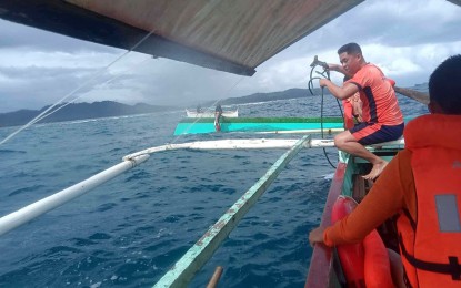 <p><strong>TO THE RESCUE.</strong> Personnel from the Coast Guard Sub-Station in Cantilan, Surigao del Sur rescue three individuals onboard a motor banca, which capsized on Dec. 13, 2023 due to strong waves. Authorities say the watercraft was transporting a casket with a cadaver.<em> (Photo courtesy of CGS-Cantilan)</em></p>