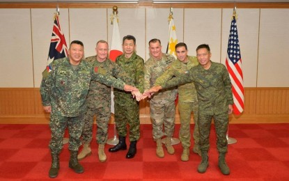 <p><strong>ARMY FORCE.</strong> Philippine Army commander Lt. Gen. Roy Galido (right) links hands with leaders from the US Army Pacific, Japan Ground Self-Defense Force, Australian Army and the Philippine Marine Corps during the Land Forces Summit (LFS) at Camp Ichigaya, Shinjuku, Tokyo from Dec. 12 -14, 2023. The four-way summit aimed to build relations among countries in the Indo-Pacific region. <em>(Photo courtesy of the Japan Ground Self-Defense Force)</em></p>