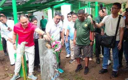<p><strong>WATER FROM THE SUN</strong>. Quezon 2nd District Rep. David Suarez (left) releases water during the inauguration of the solar-powered water system in Barangay Domoit, Lucena City on Monday (Dec. 18, 2023). The water facility is capable of supplying unlimited water to almost 500 households in two zones within the barangay. <em>(Photo by Belinda Otordoz)</em></p>