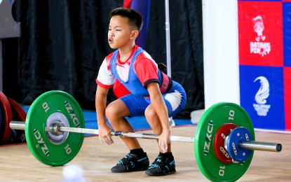 <p><strong>WINNER</strong>. Zamboanga City's Adrian Bucol dominates the 32kg category in the boys 12-under of the Batang Pinoy weightlifting competition at the Rizal Memorial Sports Complex on Monday (Dec. 18, 2023). Bucol tallied 103kgs (45kgs in snatch and 58kgs in clean and jerk). <em>(PSC media pool photo)</em></p>