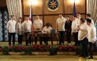 <p><strong>SIGNING OF 2024 BUDGET.</strong> President Ferdinand R. Marcos Jr. on Wednesday (Dec. 20, 2023) signs the 2024 General Appropriations Act (GAA) of 2024 in a ceremony at the Malacañan Palace in Manila. The 2024 GAA, otherwise known as Republic Act 11975, contains the 2024 national budget amounting to PHP5.768 trillion. <em>(PNA photo by Rey Baniquet)</em></p>