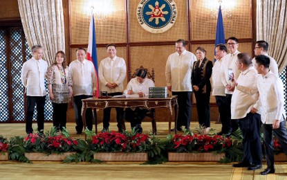 <p><strong>ENSURING ECONOMIC GROWTH.</strong> President Ferdinand R. Marcos Jr. signs the 2024 General Appropriations Act (GAA) which contains the PHP5.768-trillion budget on December 20, 2023. Economic managers said the timely passage of the 2024 national budget is expected to support the country’s economic growth and ensure the seamless delivery of government programs and services, which are much needed to pursue social and economic transformation. <em>(PNA photo by Rey Baniquet)</em></p>