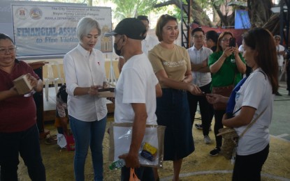 <p><strong>AID FOR FIRE VICTIMS.</strong> Manila Mayor Honey Lacuna (2nd from left) leads the distribution of cash and food assistance to victims of recent fires in the city on Thursday (Dec. 21, 2023). A total of nine fires occurred in the city from Nov. 10 to Dec. 13. <em>(Photo courtesy of Manila City Hall Reporters' Association)</em></p>