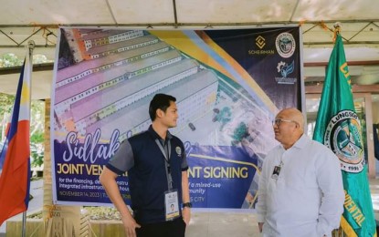 <p><strong>HOUSING PROGRAM.</strong> Victorias City Mayor Javier Miguel Benitez (left) with Scheirman Construction Consolidated Inc. Director and Chief Strategy Officer Armando Inabangan Jr. during the signing of the joint venture agreement for the development of the Sidlak Village last month. “All papers are done. We are finalizing the design. It will start the first quarter of next year,” Benitez said on Friday (Dec. 22, 2023). (<em>Photo courtesy of Victorias City Information Office</em>)</p>