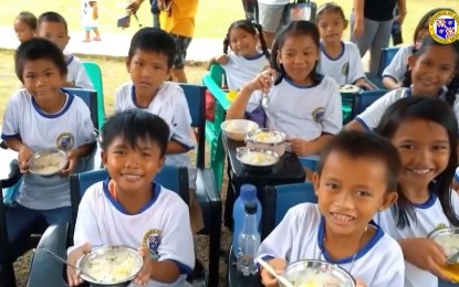 <p><strong>FEEDING THE KIDS.</strong> Learners in one of the 1,594 public schools in Cebu province enjoy their nutritious porridge prepared by the Parents-Teachers Association. The Sugbo School Feeding Program is a project of the Cebu province under Gov. Gwendolyn Garcia and supported by the private sector. <em>(Screenshot from Cebu Capitol PIO video) </em></p>