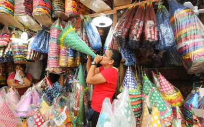 <p><strong>SAFE HOLIDAYS.</strong> Toy trumpets, locally known as "torotot," are sold along Tabora Street in Binondo, Manila, on Tuesday (Dec. 26, 2023), ahead of the New Year revelries. Mayor Honey Lacuna called on residents to be vigilant in celebrating the holiday season and continue observing health protocols. <em>(PNA photo by Yancy Lim)</em></p>