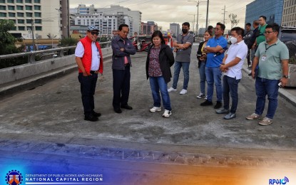 <p><strong>FINISHED.</strong> Department of Public Works and Highways Secretary Manuel Bonoan (2nd from left) leads the inspection of the rehabilitation work on the northbound lane of the Roxas Boulevard-EDSA flyover in Pasay City on Friday (Dec. 29, 2023). The flyover will reopen to motorists on Saturday night after four days of repairs.<strong> </strong><em>(Photo courtesy of DPWH-NCR) </em></p>