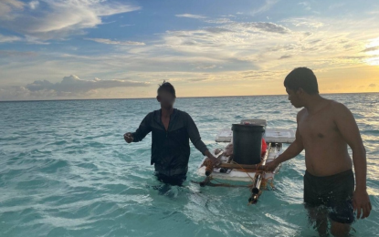 <p><strong>SURVIVOR</strong>. Fisherman Rosalon Cayon (left) is assisted by a soldier stationed at Rizal Reef Detachment in the West Philippine Sea after his rescue on Monday (Jan. 1, 2024). Seen here is the improvised lifesaver he made from mostly styrofoam.<em> (Photo courtesy of Western Command)</em></p>