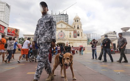 <p><strong>SOLEMN OBSERVANCE. </strong>Members of the Philippine Coast Guard, alongside their K-9 dogs, stand guard in front of the Quiapo church in Manila on Jan. 5, 2024. The city government of Manila will implement a liquor ban within the 500-meter radius of all Catholic churches in the city on Holy Thursday and Good Friday, to ensure a solemn observance of the Holy Week. <em>(PNA file photo by Yancy Lim)</em></p>
