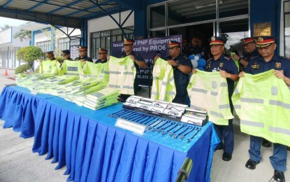 <p><strong>NON-LETHAL.</strong> Police Regional Office-6 Director Brig. Gen Sidney Villaflor (5th from left) and other officials show the reflectorized raincoat intended for police stations in Western Visayas on Monday (Jan. 15, 2024). A total of 2,417 reflectorized raincoats and 2,000 whistles worth PHP2.64 million were turned over to police stations after the flag-raising ceremony at the regional headquarters in Iloilo City. <em>(PNA photo by PGLena)</em></p>
<p> </p>