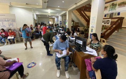 <p><strong>TAX SEASON</strong>. Business owners line up to avail of the services of a one-stop shop at Pagudpud municipal hall lobby on Monday (Jan. 15, 2024). The Ilocos Norte government extended the deadline for the payment of taxes and other government fees until Feb. 29. <em>(Photo courtesy of Pagudpud LGU)</em></p>