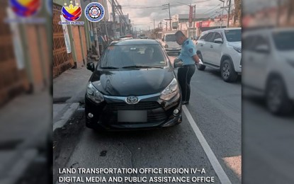 <p><strong>ANTI-COLORUM OPS.</strong> A enforcer from the Land Transportation Office-Calabarzon inspects a vehicle's registration in this undated photo. The LTO on Friday (Feb. 2, 2024) said a total of 272,233 delinquent vehicles were registered in January following the agency's crackdown on unregistered vehicles.<em> (Photo courtesy of LTO-Calabarzon)</em></p>