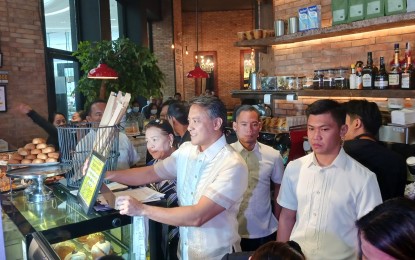 <p><strong>TAX COMPLIANCE. </strong>Bureau of Internal Revenue (BIR) Commissioner Romeo Lumagui Jr. properly placed a notice on receipt issuance in a visible area inside a business establishment in Mandaluyong on Thursday (Jan. 18, 2024). Lumagui visited several establishments in the city for the first day of the BIR's tax compliance verification drive. <em>(PNA photo by Marita Moaje) </em></p>