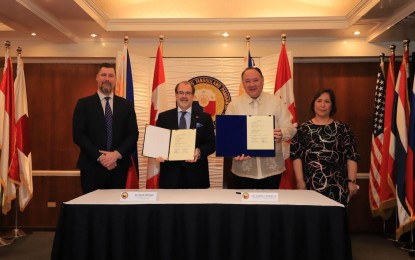 <p><strong>DEFENSE TIES. </strong>Canadian Ambassador to the Philippines, David Bruce Hartman (2nd left), and Defense Secretary Gilberto C. Teodoro Jr. (right) show the memorandum of understanding (MOU) for Defense Cooperation between the two nations on Friday (Jan. 19, 2024). The MOU jumpstarts cooperation between the defense and military establishments of Philippines and Canada on military education, training exchanges, among others. <em>(Photo courtesy of DND) </em></p>